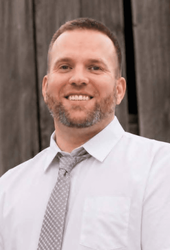 Smiling bearded man in white shirt and tie