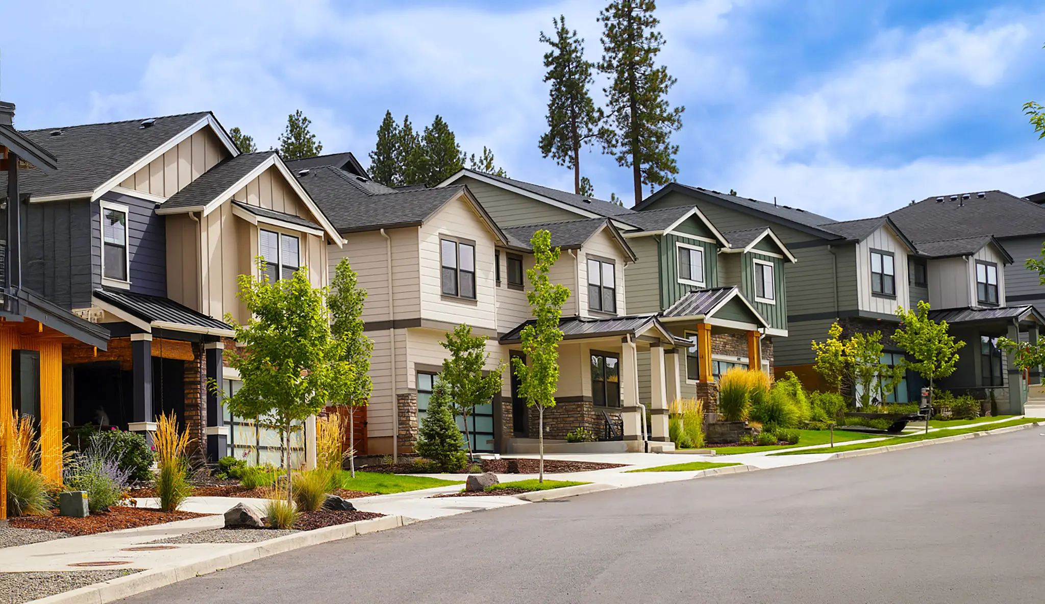 Row of modern suburban houses with front lawns